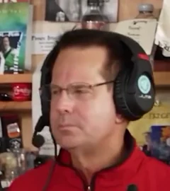 Right backing singer: Screen right · red jacket, glasses